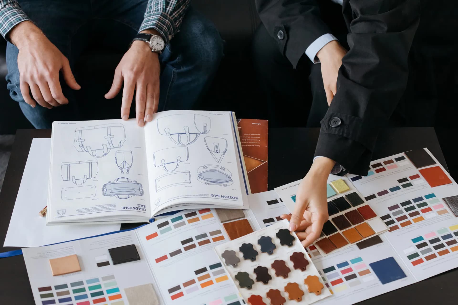 Product sketches and colour swatches spread across a table.